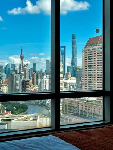 a view of a city skyline from a window at River House Near The Peoples Square And The Bund in Shanghai