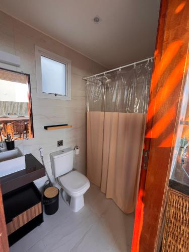 a bathroom with a toilet and a sink and a shower at SW Rustica Apartamentos in Canoa Quebrada