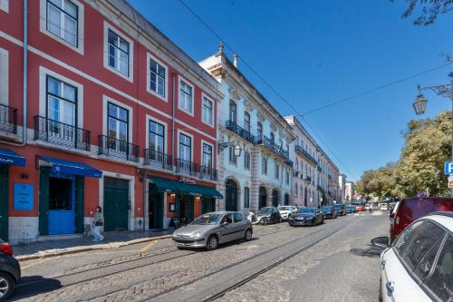 a city street with cars parked on the street at Gloria Guesthouse in Lisbon