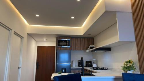 a kitchen with a dining table and a kitchen with at Espectacular y exclusivo departamento en Monterrey in Monterrey