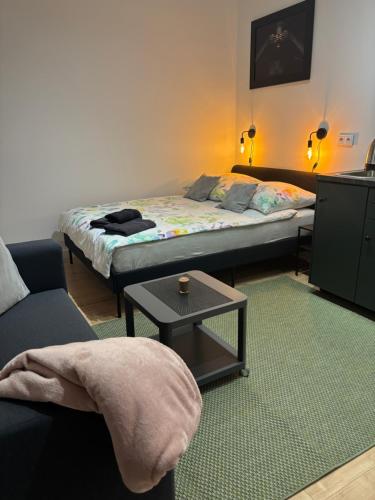 a small room with two beds and a table at Apartament Trocera 2 in Zabrze