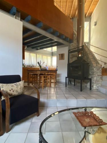 a living room with a fireplace and a table at Ample Places in Pano Lefkara