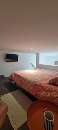 a bedroom with a bed and a table in a room at Studio 2 terrasse aperçu mer vignes in Saint-Cyr-sur-Mer