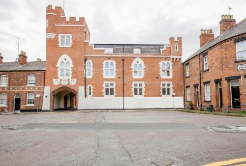 a large red brick building with white windows at The Penthouses, 8 Albion Mews in Chester