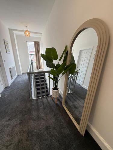 a hallway with a mirror and a potted plant at ResiLets Barnard St NEW Large 4 Bed House, Contractor Stays, Central in Blythe