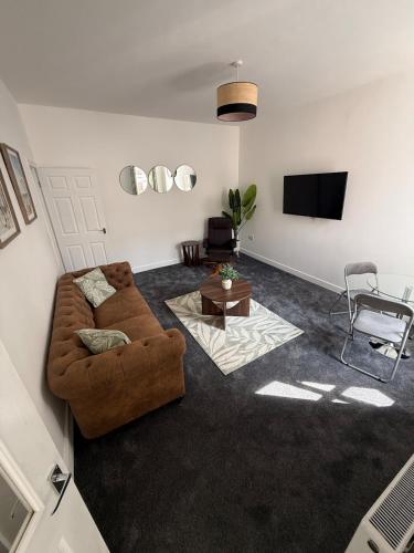 a living room with a couch and a tv at ResiLets Barnard St NEW Large 4 Bed House, Contractor Stays, Central in Blythe