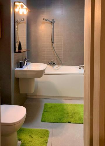 a bathroom with a sink and a toilet and a tub at Independence Studio in Bucharest