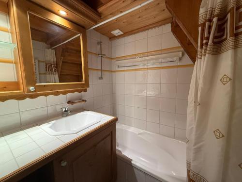 a bathroom with a sink and a bath tub at Appartement spacieux aux Saisies avec piscine et parking pour 6 personnes - FR-1-293-360 in Hauteluce