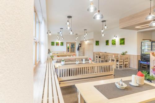 a restaurant with tables and chairs in a room at Penzion a restaurace Na Hvězdě in Malá Morávka
