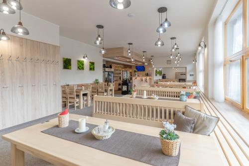 a dining room with a table and a restaurant at Penzion a restaurace Na Hvězdě in Malá Morávka