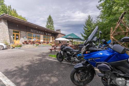 a blue motorcycle parked in front of a restaurant at Penzion a restaurace Na Hvězdě in Malá Morávka