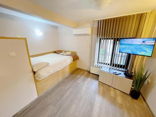 a small room with a bed and a flat screen tv at Studio Apartment Tsar Kaloyan Near Tsarevets in Veliko Tŭrnovo