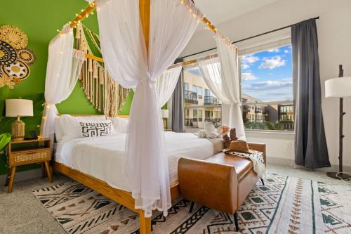 a bedroom with a canopy bed and a window at Lookout Luxe 2BR | Shuffleboard | Classy | 1GB in Dallas