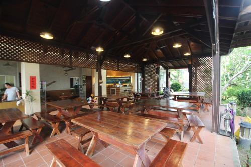 an empty restaurant with wooden tables and chairs at 潔坊琳居民宿 JayLin Home in Yuchi