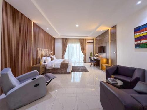 a hotel room with a bed and a living room at NA Conference Centre And Suite in Karsana