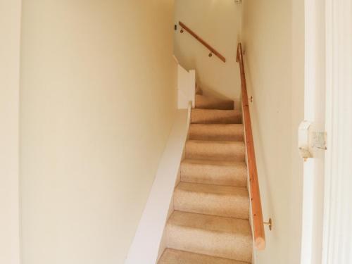 a staircase in a home with white walls at Over Village Studio in Over