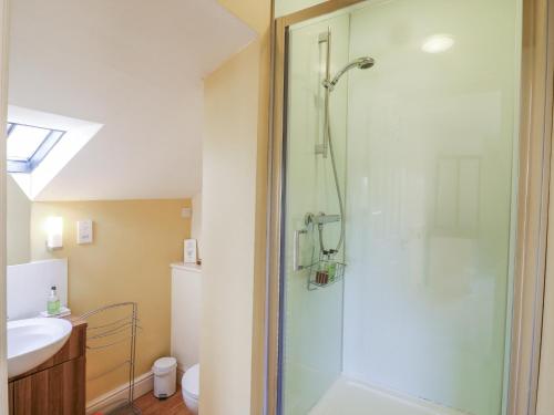 a bathroom with a shower and a sink at Over Village Studio in Over