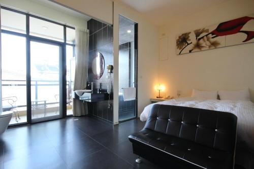 a bedroom with a bed and a bathroom with a mirror at 潔坊琳居民宿 JayLin Home in Yuchi