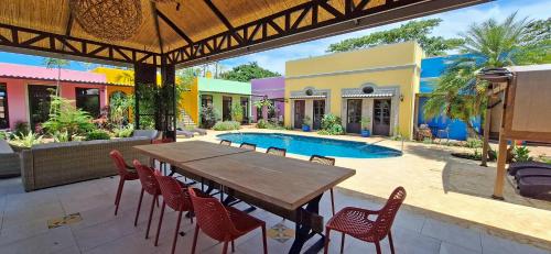 a patio with a table and chairs and a pool at Club Heasa - Men Only in La Garita