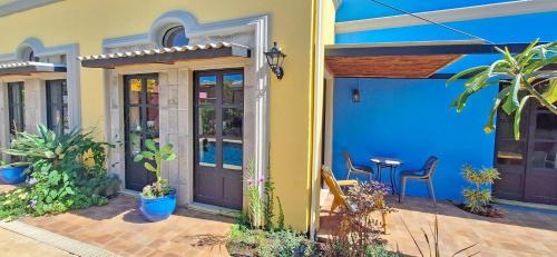 a house with a blue front door and a table at Club Heasa - Men Only in La Garita