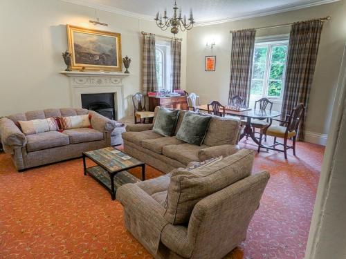 a living room with two couches and a dining room at Uphill Manor Bed & Breakfast in Uphill