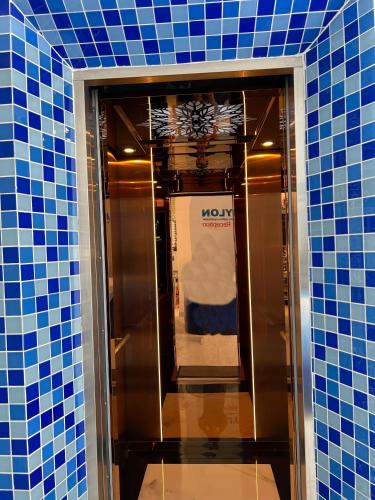an elevator in a room with blue tiles at Babylon Hotel Phu Quy in Îlot du Sud