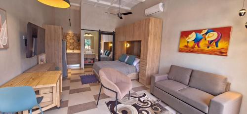 a living room with a bed and a couch at Club Heasa - Men Only in La Garita