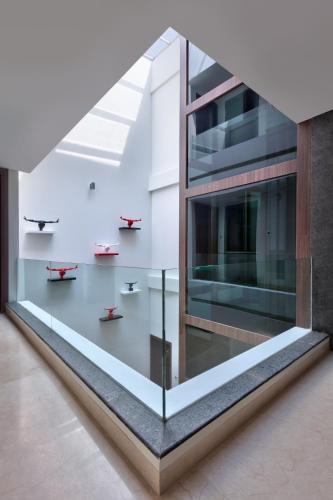 a glass wall in a building with red benches at The Atara Near Golf Course Road in Gurgaon