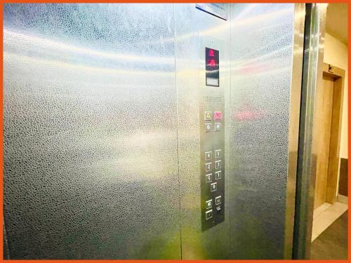 an elevator door with a red light on it at HOTEL PRIME J & K INN - NEAR SEA BEACH - Restaurant - #Lift And Parking Facilities - #fully Air Conditioned hotel at Prime Location - #BREAKFAST included -LUXURAY HOTEL IN PURI in Puri