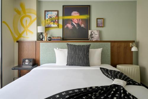a bedroom with a bed with a white bedspread at Generator Hotel Washington DC in Washington
