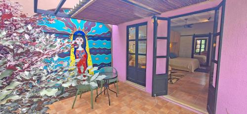 a room with a painting of a woman on the wall at Club Heasa - Men Only in La Garita