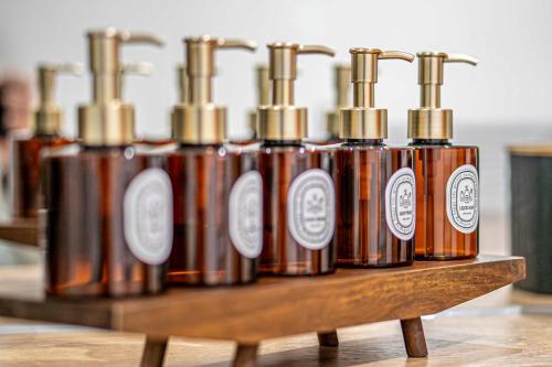 a row of copper bottles on a wooden shelf at Luxury 2BR Penthouse-1, Private Terrace, City Center, Free Parking in Leeds