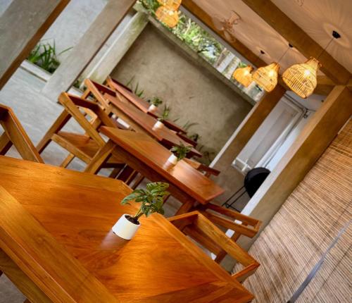 an overhead view of a restaurant with wooden tables and chairs at Brinkhouse Guesthouse , Unawatuna beach in Unawatuna