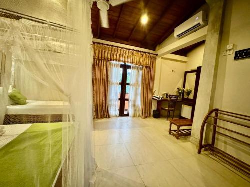 a bedroom with a bed with a veil on it at Brinkhouse Guesthouse , Unawatuna beach in Unawatuna