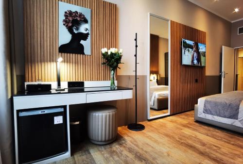 a hotel room with a desk and a bedroom at Arthotel Munich in Munich