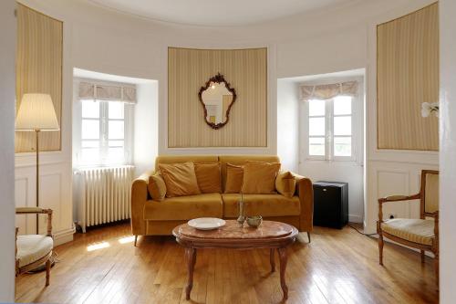 a living room with a couch and a table at Hattonchatel Château & Restaurant La Table du Château in Hattonchâtel