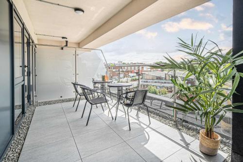 a balcony with chairs and a table with a view at Leeds City Centre 2BR Apartment - Luxury Stay with Private Terrace in Leeds