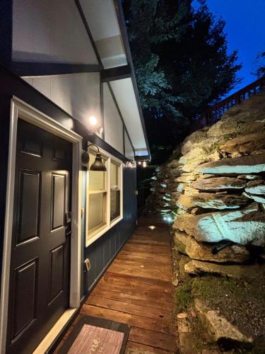 a door to a house with a stone wall at Cozy cabin with boosted Wi-Fi in Beech Mountain