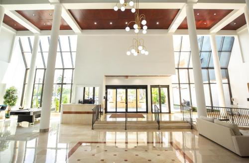 a lobby with large glass windows and a staircase at Logis Auberge La Diege in Capdenac-Gare