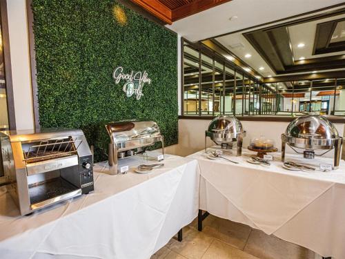 two tables in a restaurant with two food stations at Logis Auberge La Diege in Capdenac-Gare