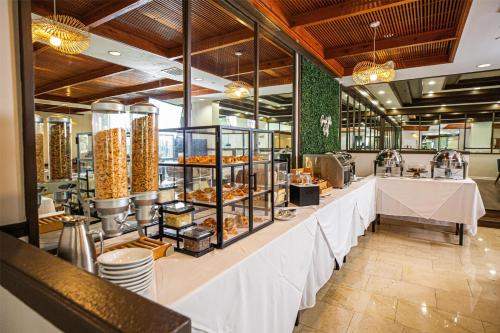 a bakery with a long counter with food at Logis Auberge La Diege in Capdenac-Gare