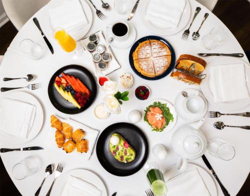a white table with plates of food on it at Logis Auberge La Diege in Capdenac-Gare