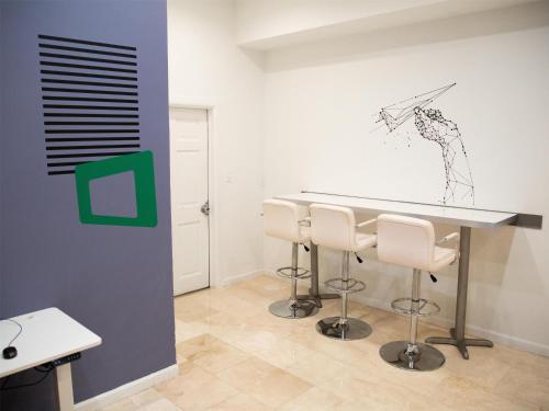 a room with a table with chairs and a drawing on the wall at Logis Auberge La Diege in Capdenac-Gare