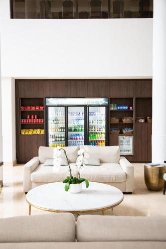 a living room with two couches and a table at Logis Auberge La Diege in Capdenac-Gare