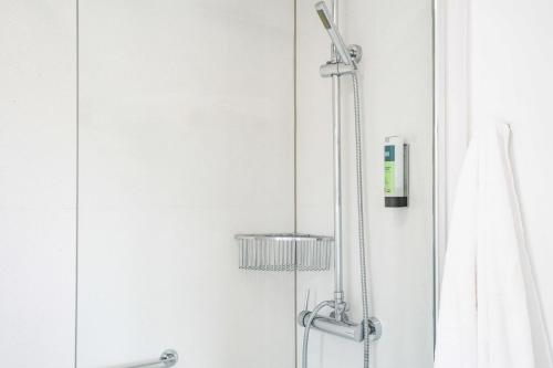 a shower with a shower head in a bathroom at Logis Hôtel Baratxartea in Sare