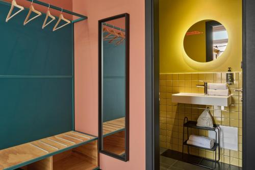 a bathroom with a mirror and a sink at JO&JOE ROMA in Rome