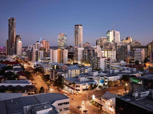 a city skyline at night with tall buildings at The Johnson Brisbane - Art Series in Brisbane