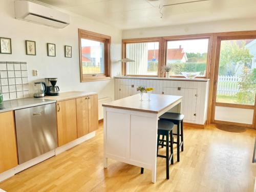 a kitchen with a white island and a counter top at Light-filled and spacious villa on Vrångö Island in Vrångö