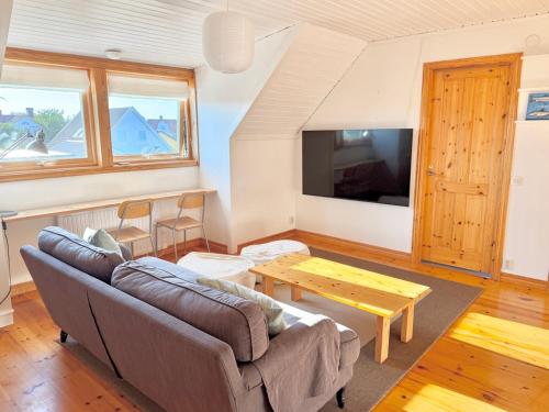 a living room with a couch and a table at Light-filled and spacious villa on Vrångö Island in Vrångö