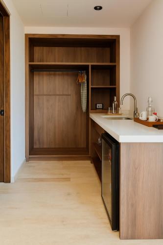 a kitchen with a wooden door and a counter at Hotel Flores de Sal-Valle de Guadalupe in Valle de Guadalupe